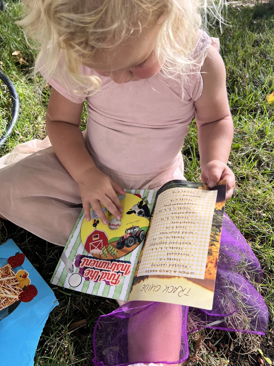 Toddler reading the Mailbox Melodies booklet