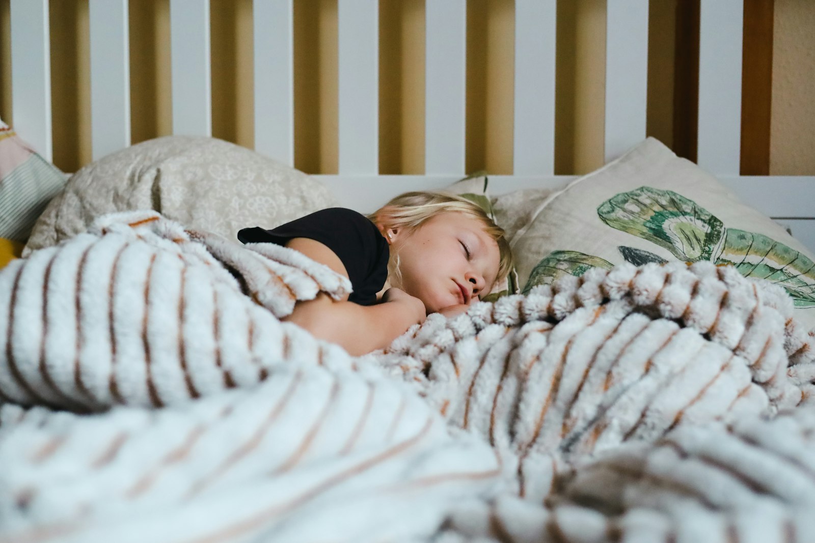Little girl sound asleep under a cozy blanket