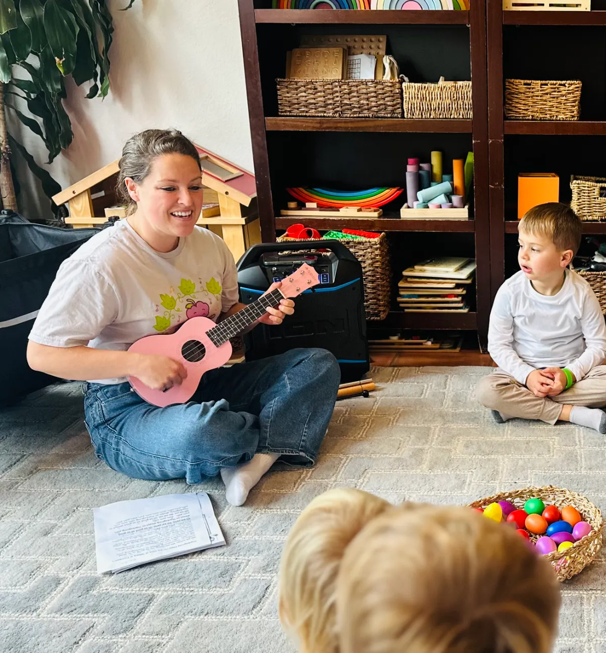 Ms. Chelsea playing ukulele in a toddler music class
