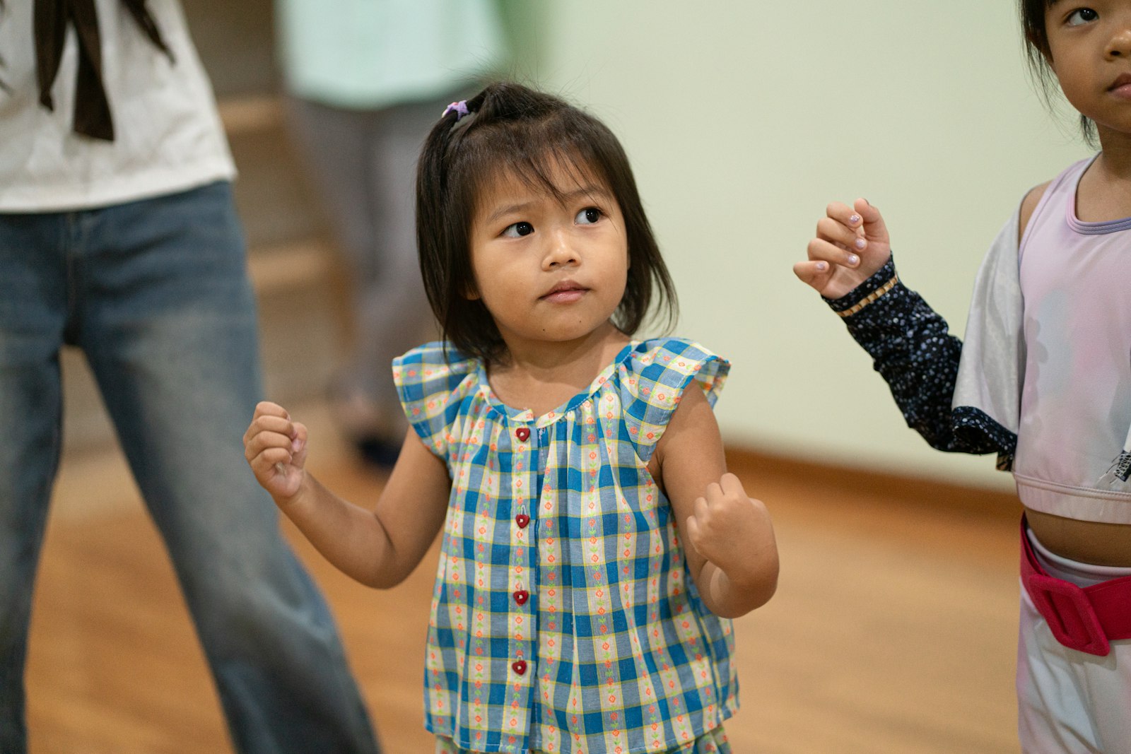 Young children dancing together in a music class