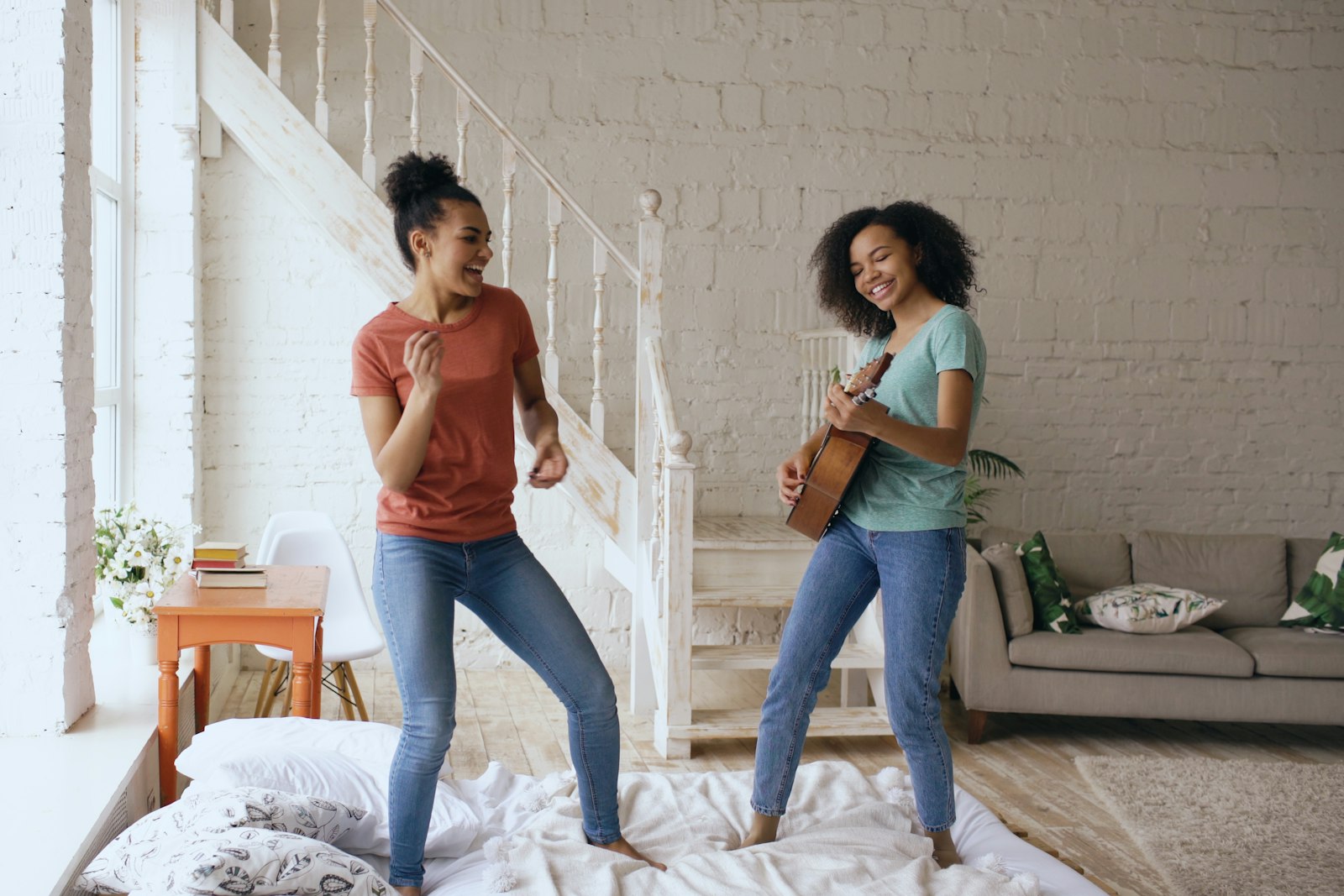 A parent and child dancing together in a bright living room