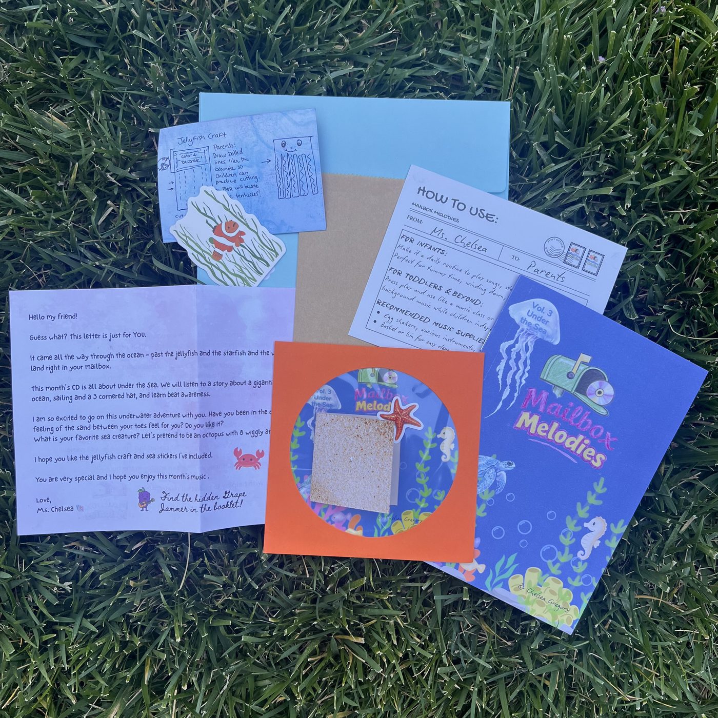 Everything inside the Under the Sea envelope laid out on the grass