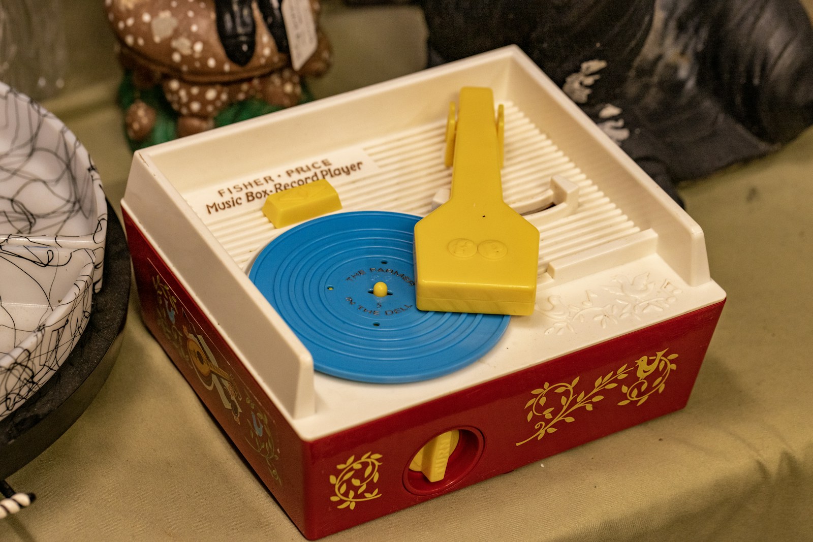 A child's toy record player on a table, a screen-free way for kids to run their own listening