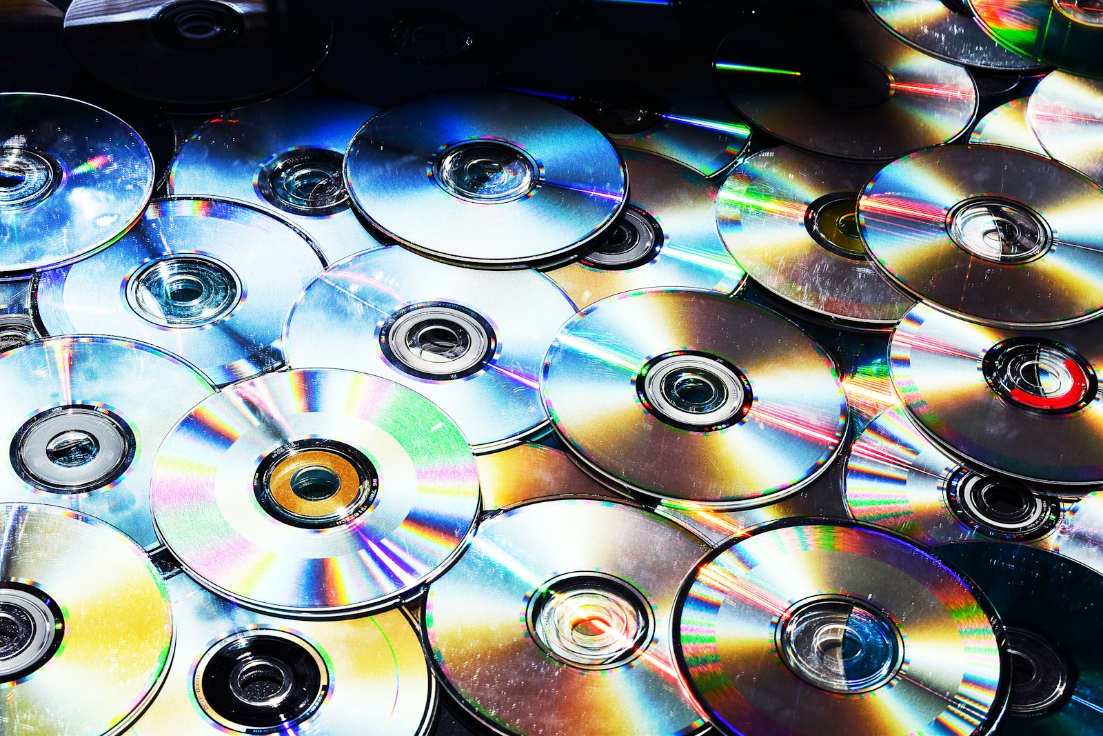 A collection of CDs, the physical side of kids music subscription cost