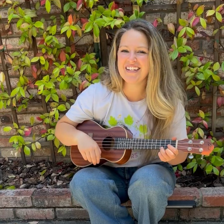 Ms. Chelsea playing ukulele, ready for the monthly live music class