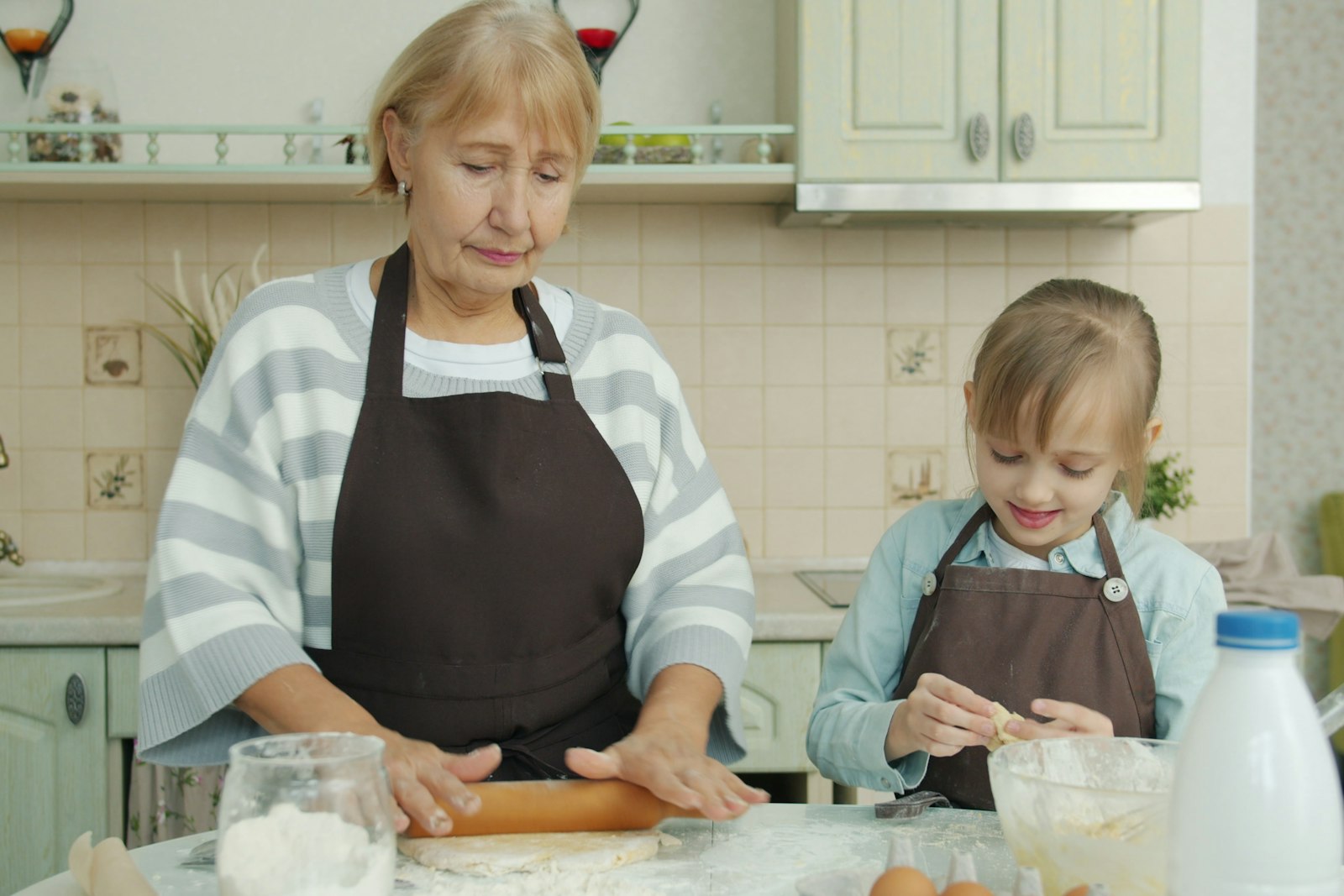 A grandmother and her grandchild baking together in the kitchen, the kind of time that makes the best Christmas gifts for grandchildren